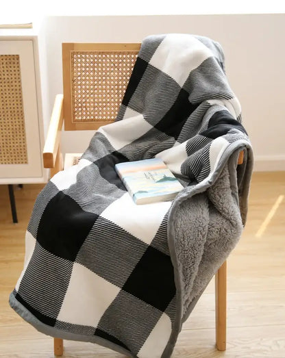 Cozy black and white plaid sofa blanket with soft gray winter coral fleece lining for living room comfort