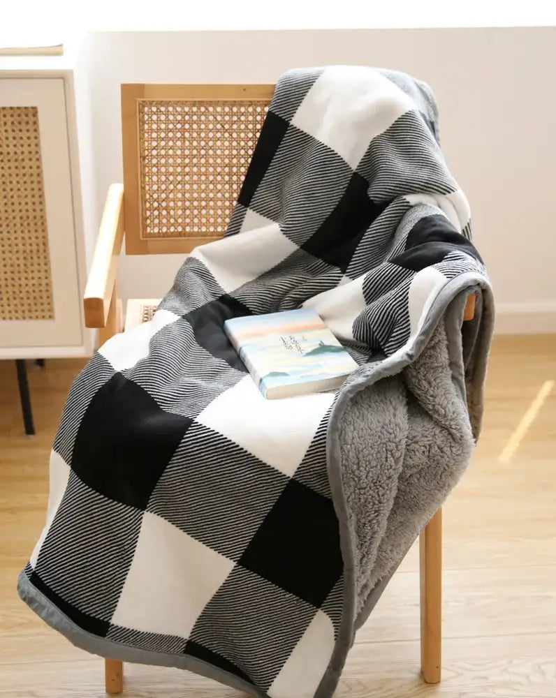 Cozy black and white plaid sofa blanket with soft gray winter coral fleece lining for living room comfort