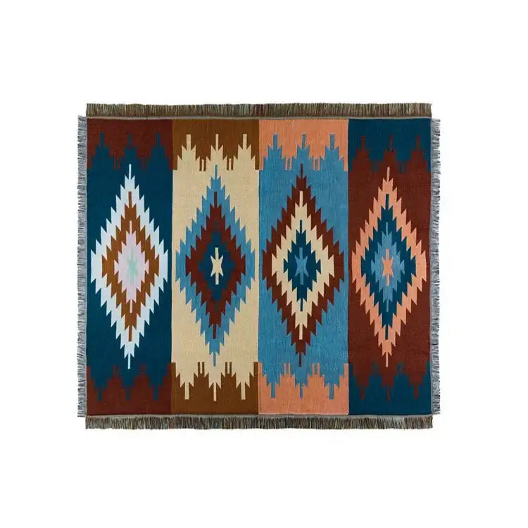 A rectangular decorbites bohemian nordic woven rug with bold teal orange geometric diamond patterns and fringed edges