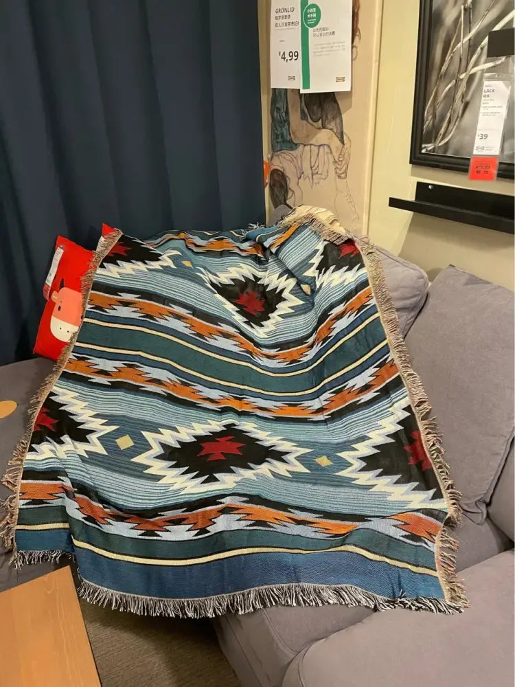 A decorbites bohemian nordic leisure throw blanket with teal orange geometric pattern and fringed edges for bedroom decor
