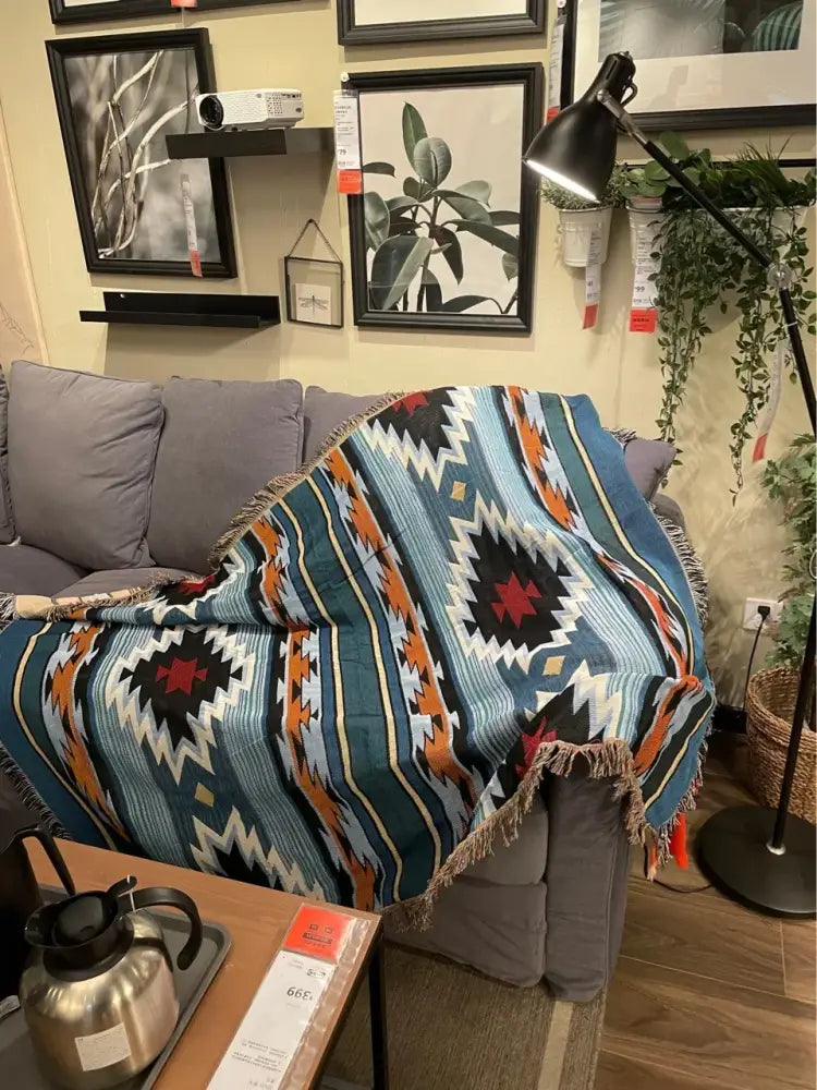 A vibrant decorbites bohemian nordic leisure throw blanket in teal orange geometric pattern with fringed edge for bedroom decor