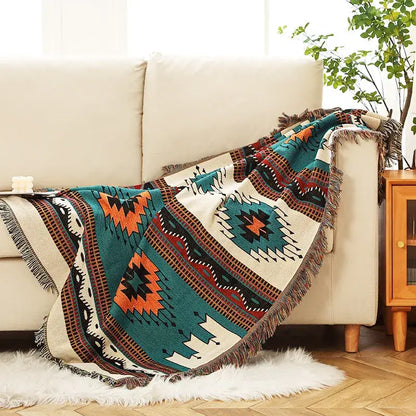 A cream bohemian throw blanket with teal orange black geometric patterns and fringed edges for bedroom decorbites bohemian decor