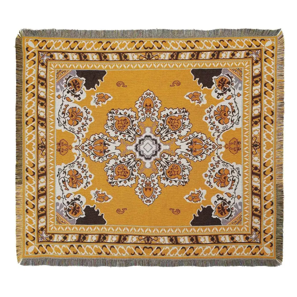 A decorbites bohemian outdoor blanket with mustard yellow base and intricate floral paisley pattern with fringed edges