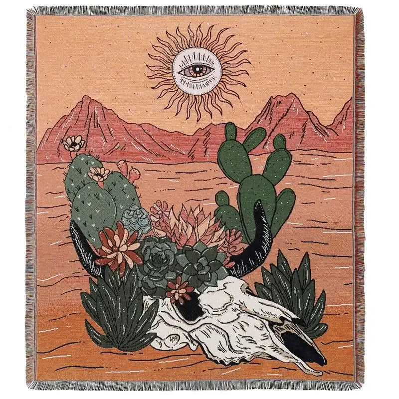 A decorbites bohemian outdoor blanket featuring a woven desert scene tapestry with cacti and eye-in-the-sun motif on orange