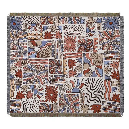 A decorbites bohemian outdoor blanket with vibrant rust blue floral geometric pattern on off-white gray tiger tapestry rug