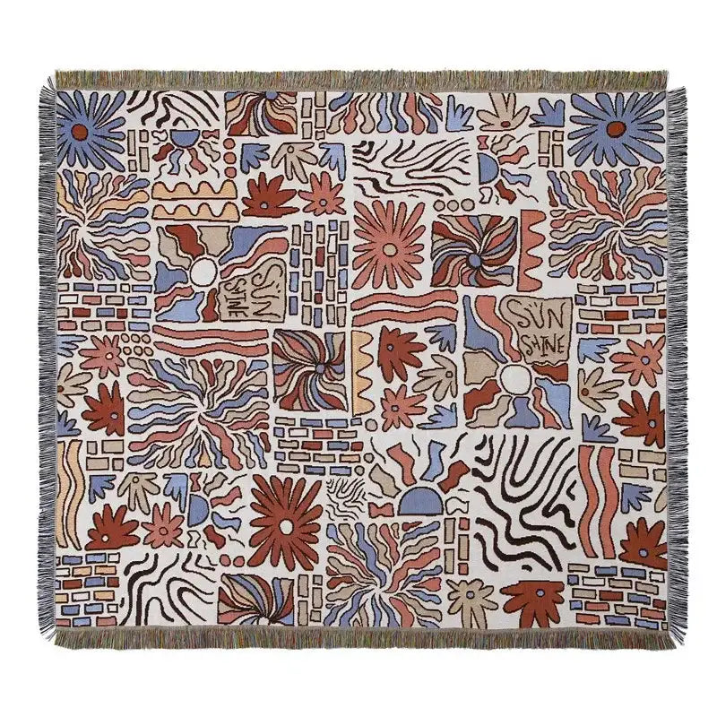 A decorbites bohemian outdoor blanket with vibrant rust blue floral geometric pattern on off-white gray tiger tapestry rug