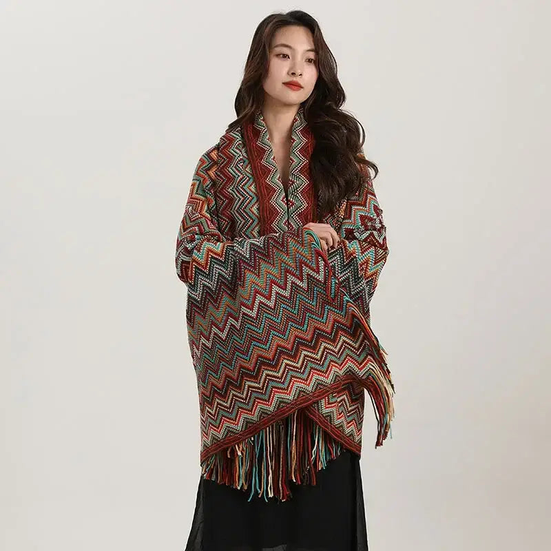 A vibrant bohemian red and teal knit wavy fringe shawl with zigzag pattern and fringe detailing for living room use