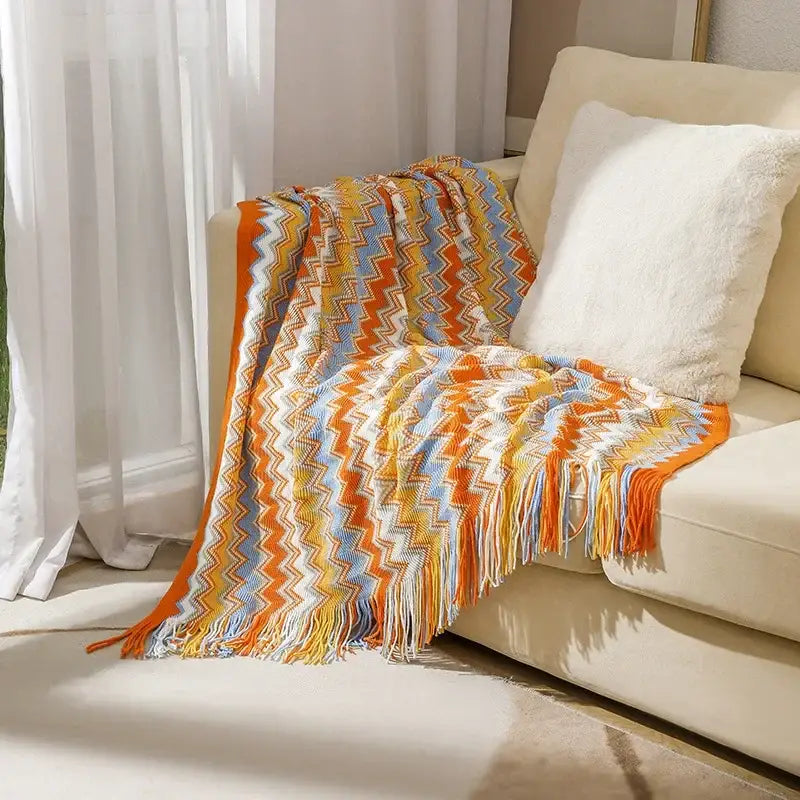Bohemian stripe throw blanket with vibrant orange yellow and blue zigzag knit and fringe for living room decorbites