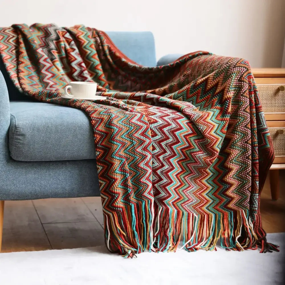 Bohemian stripe throw blanket featuring a cozy multicolored zigzag knit with fringe in earthy and teal tones by decorbites