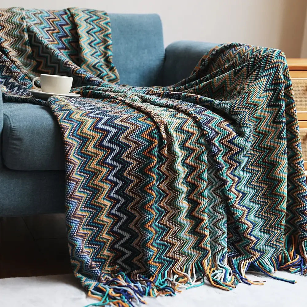 Cozy bohemian stripe throw blanket with multicolored teal navy orange beige knit and fringed edges for living room decorbites