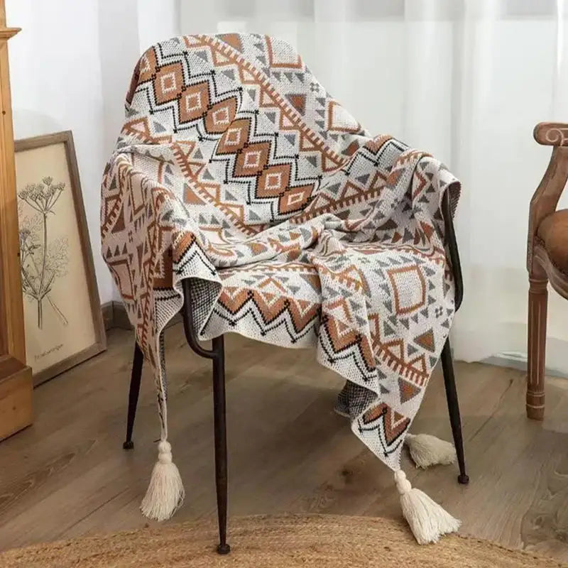 Cozy bohemian striped knit throw blanket in beige brown with geometric pattern and tassels for living room decorbites decor