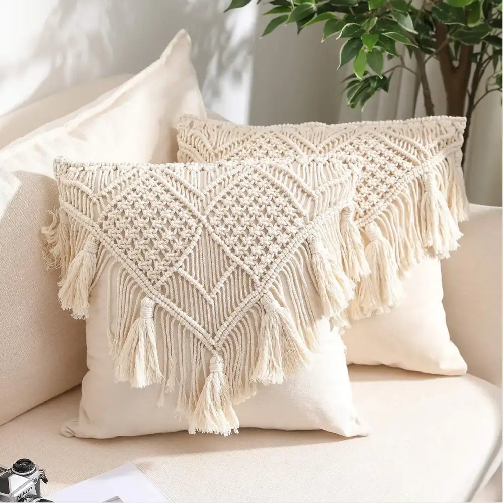 Cream-colored bohemian style beige macrame cushion cover with intricate geometric knotting and long fringe tassels decorbites