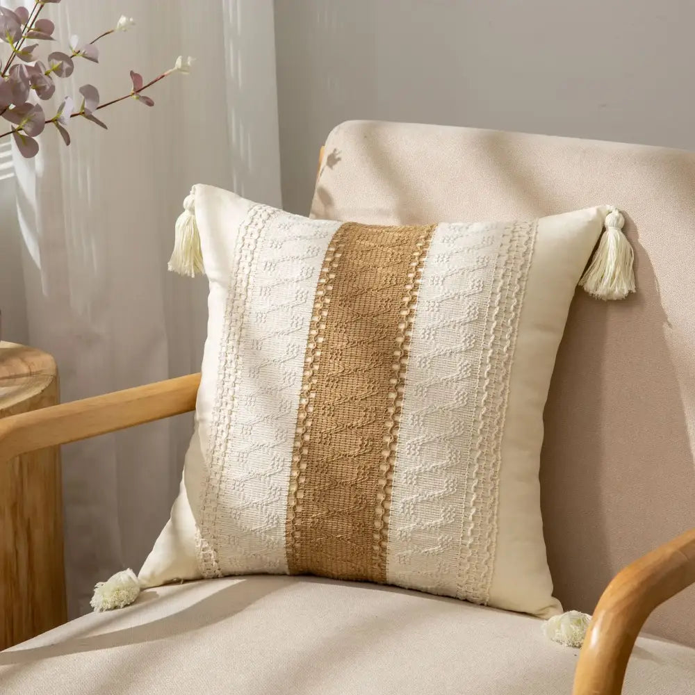Cream-colored bohemian style fringed pillow cover with tan woven stripe and white crochet tassels for living room decorbites