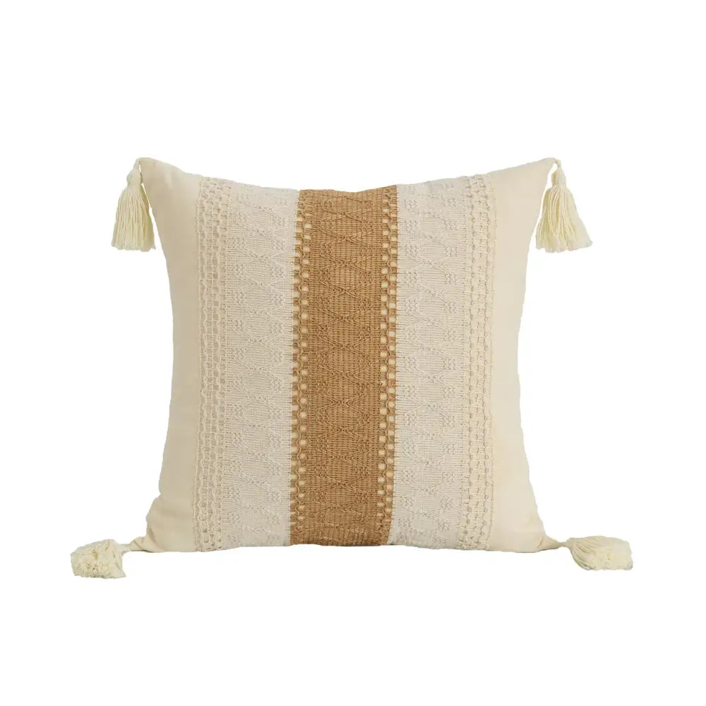 Cream-colored pillow cover with tan woven stripe, lace-like patterns, and tassels in decorbites bohemian style fringed design