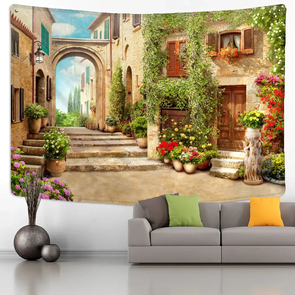 Bohemian sunlit village garden tapestry featuring stone buildings and colorful flowers for decorbites garden tapestry decor