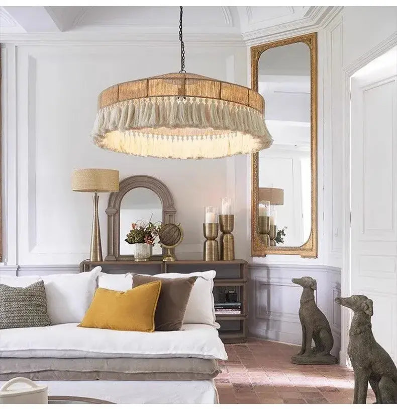 A rustic wooden bohemian tassel chandelier with a circular frame and natural woven tassels for bedroom decorbites lighting