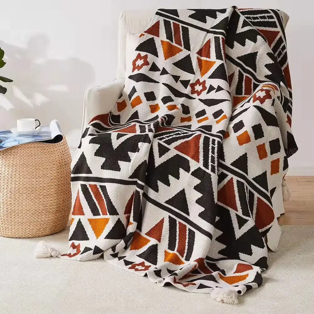 Cozy bohemian tassel knit blanket with bold black orange and white geometric pattern and tassels for decorbites decor