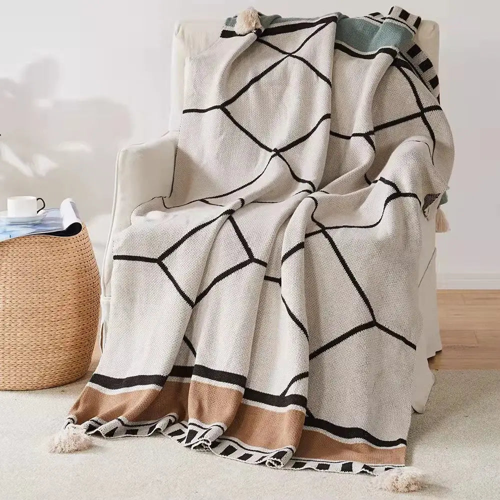 Cream-colored bohemian tassel knit blanket with black geometric patterns and beige accents for living room decorbites decor