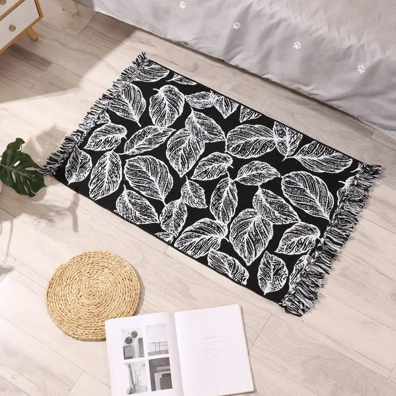 Black rectangular decorbites bohemian tassel rug with white leaf patterns and fringed edges for living room decor