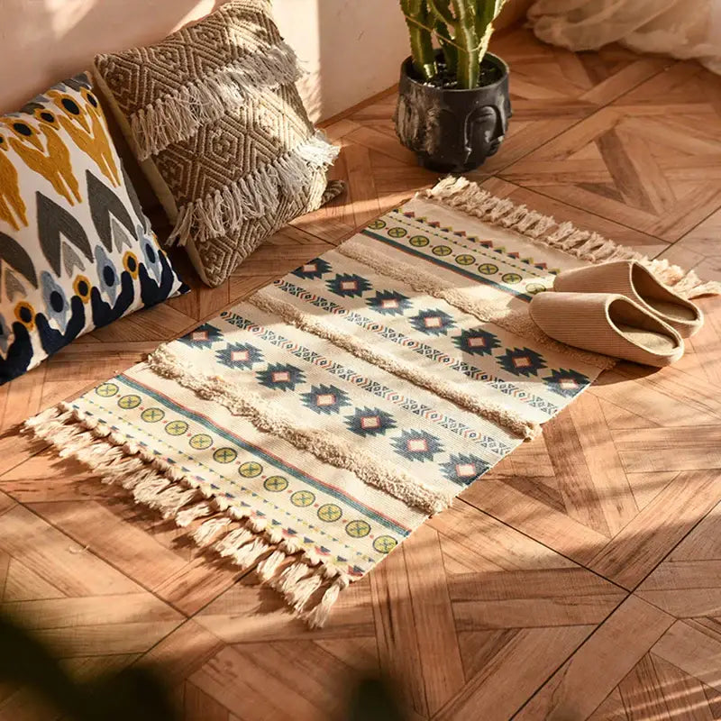 Beige woven decorbites bohemian tassel rug with blue green and brown geometric patterns and fringed edges for living room