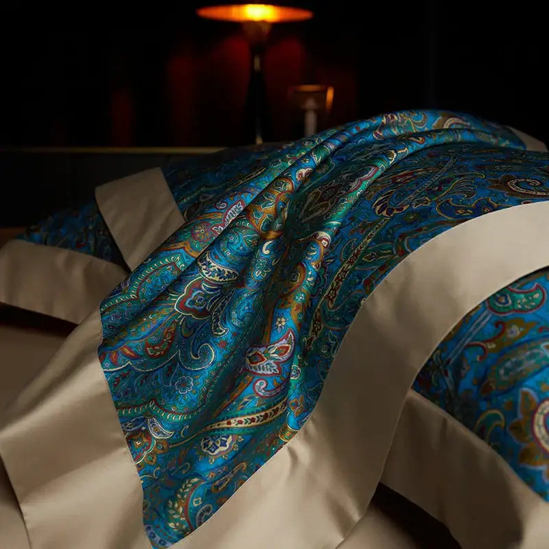 A luxurious teal and gold paisley-patterned satin bed runner with cream trim from decorbites bohemian style egyptian cotton bedding set