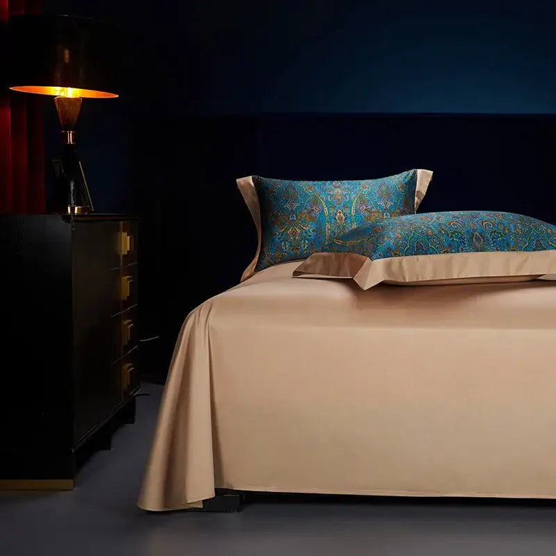 Beige satin bedsheet with blue paisley pillows featuring gold accents in decorbites bohemian style egyptian cotton bedding set