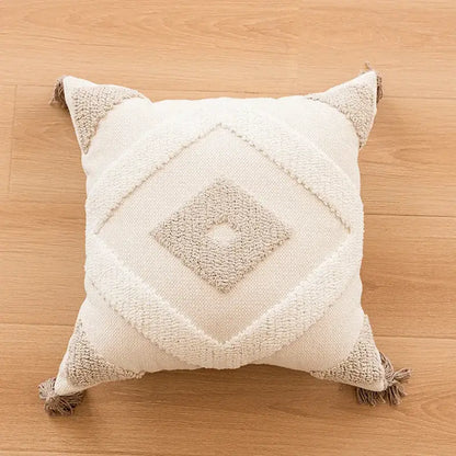 Cream-colored bohemian tufted tassel pillow with textured diamond pattern and beige tassels for living room decorbites decor