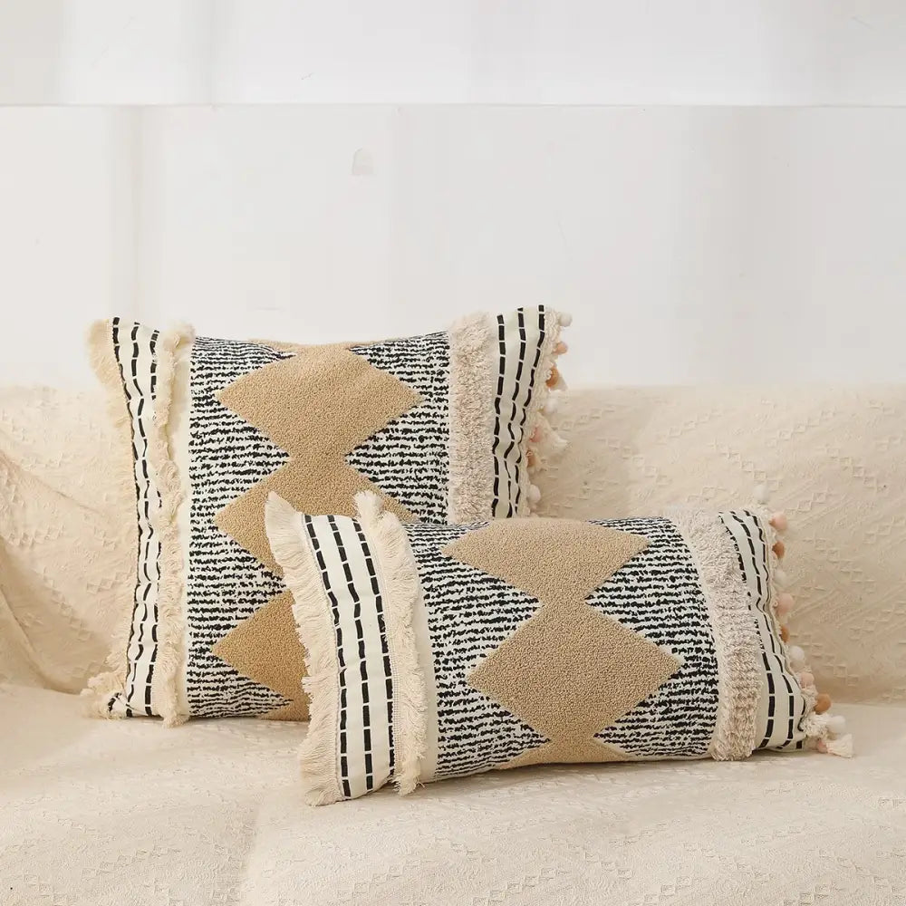 Beige and black woven bohemian tufted tassel pillow with textured star appliqués and fringed edges for living room decorbites
