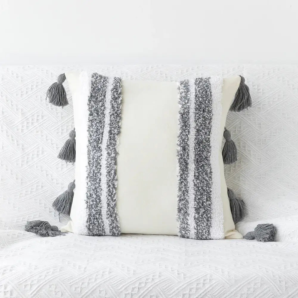 Cream-colored bohemian tufted tassel pillow with textured gray white stripes for geometric living room decorbites decor