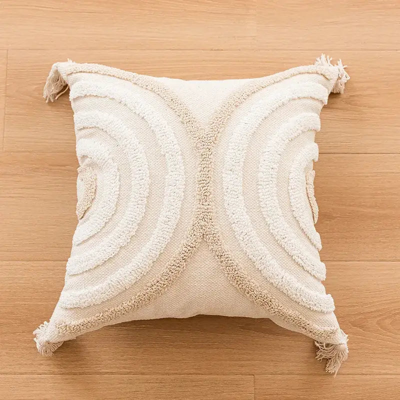 Cream-colored bohemian tufted tassel pillow with textured raised x pattern and fringed corners for living room decorbites