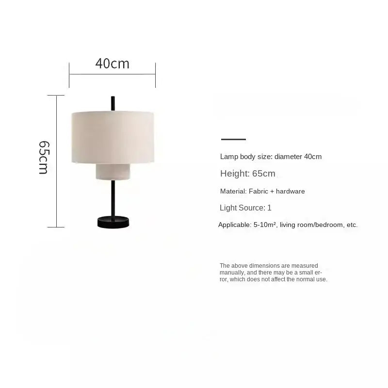 A modern black metal base table lamp with cream fabric shade complementing decorbites bohemian wabi sabi pendant lamps