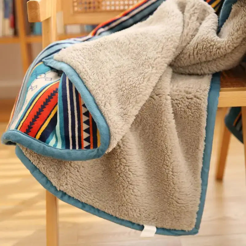 A cozy beige bohemian winter blanket with colorful stripes and teal trim made of sherpa fleece for living room use