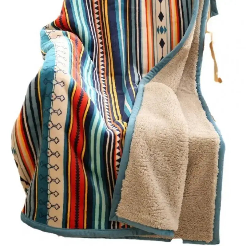 A cozy bohemian winter blanket with vibrant blue red orange and teal stripes fleece lined for living room use