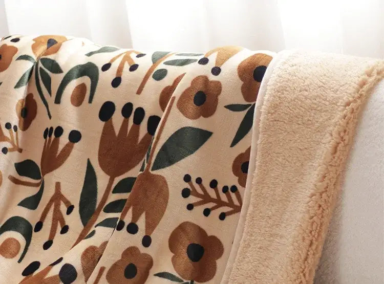 A cozy cream fleece bohemian winter blanket with plush texture and earthy floral pattern for living room use