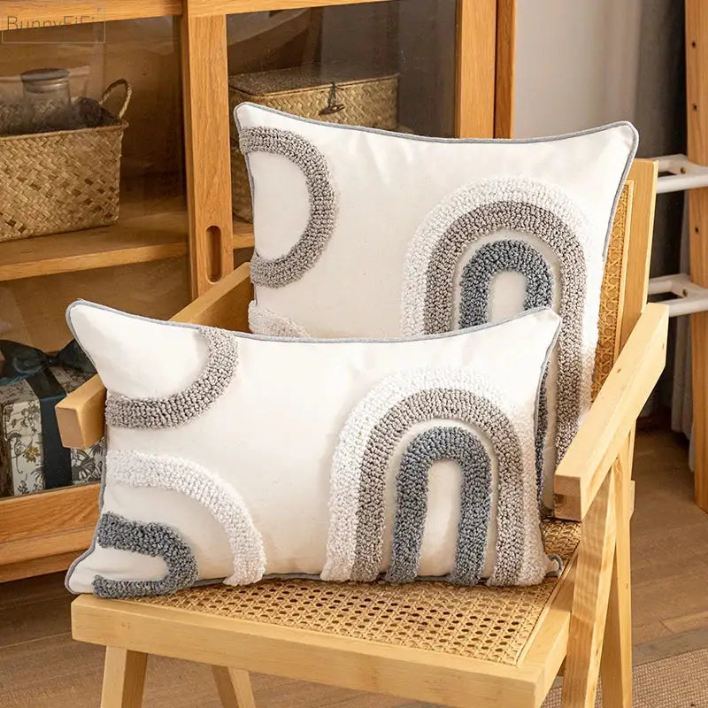 White rectangular cushion cover with textured gray and cream plush yarn arches for boho style home decoration decorbites