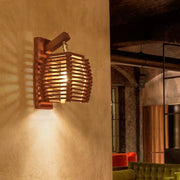 Warm-toned bamboo wall sconce with woven basket design, ideal as a boho corridor wall sconce light