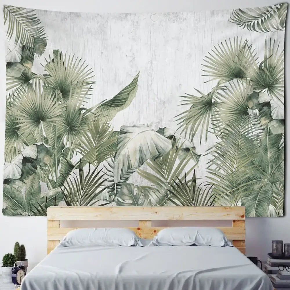A boho banana tree mist tapestry wall hanging featuring lush green tropical leaves above a wooden bed frame