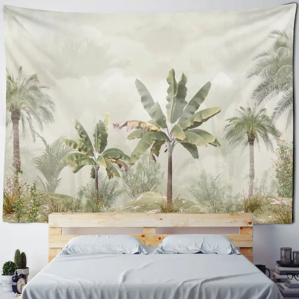 Boho banana tree mist tapestry wall hanging in soft green and beige featuring palm and banana tree motifs above wooden bed