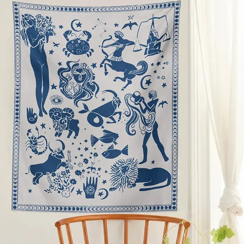 A white wall hanging with blue zodiac signs and celestial motifs in a constellation tarot boho tapestry design