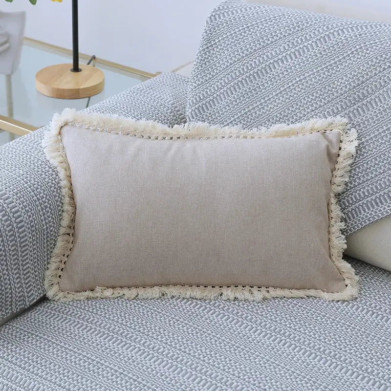 Beige rectangular boho linen pillow cover set with cream-colored tassel trim for living room sofa decor