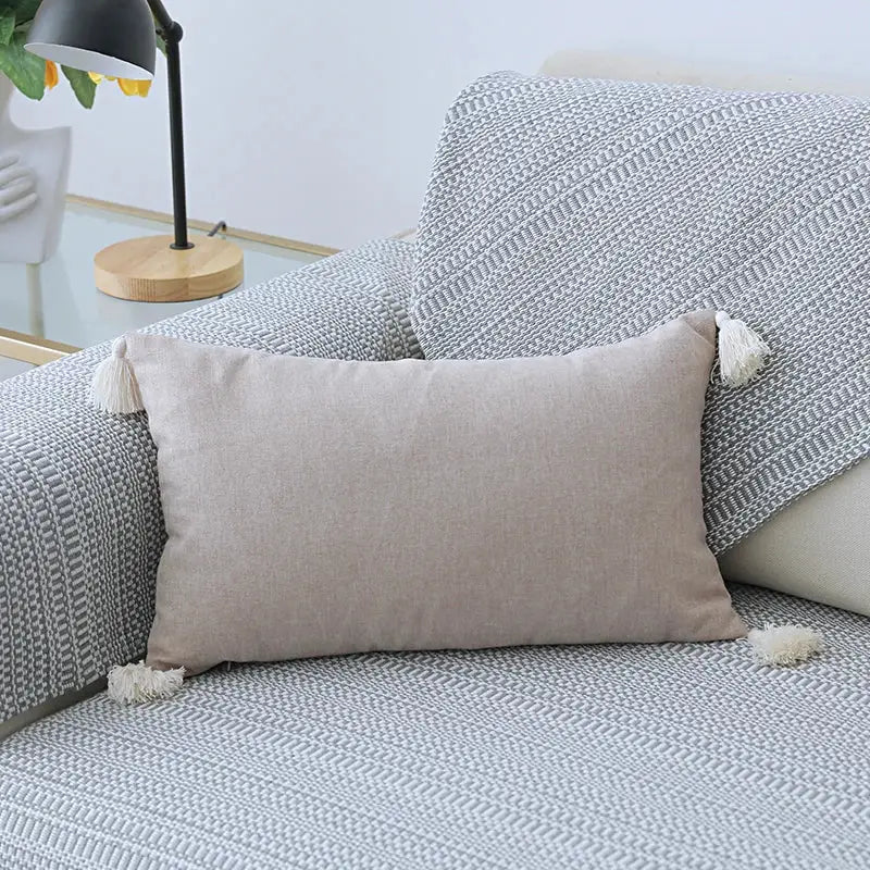 Beige rectangular boho pillow cover set with soft linen fabric and white tassels for living room sofa use