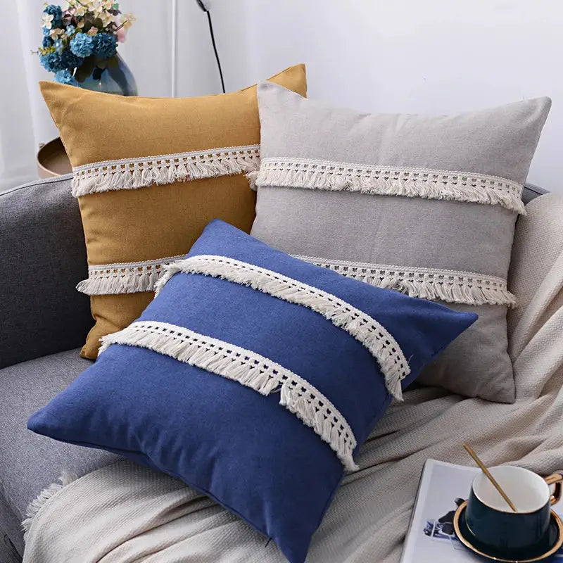 Three rectangular mustard yellow, light gray, and navy blue boho linen pillow cover set with cream macrame fringe tassels