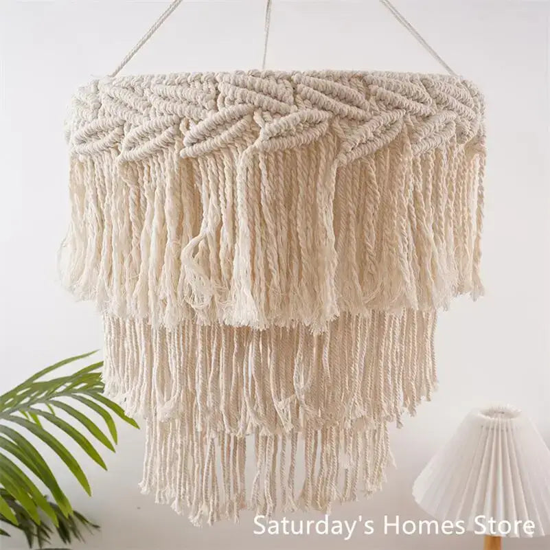 Beige macrame pendant light cover with layered fringe and intricate woven patterns for bedroom chandelier