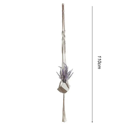 Beige macrame plant hanger basket with geometric ceramic pot holding dried lavender for boho living room decor