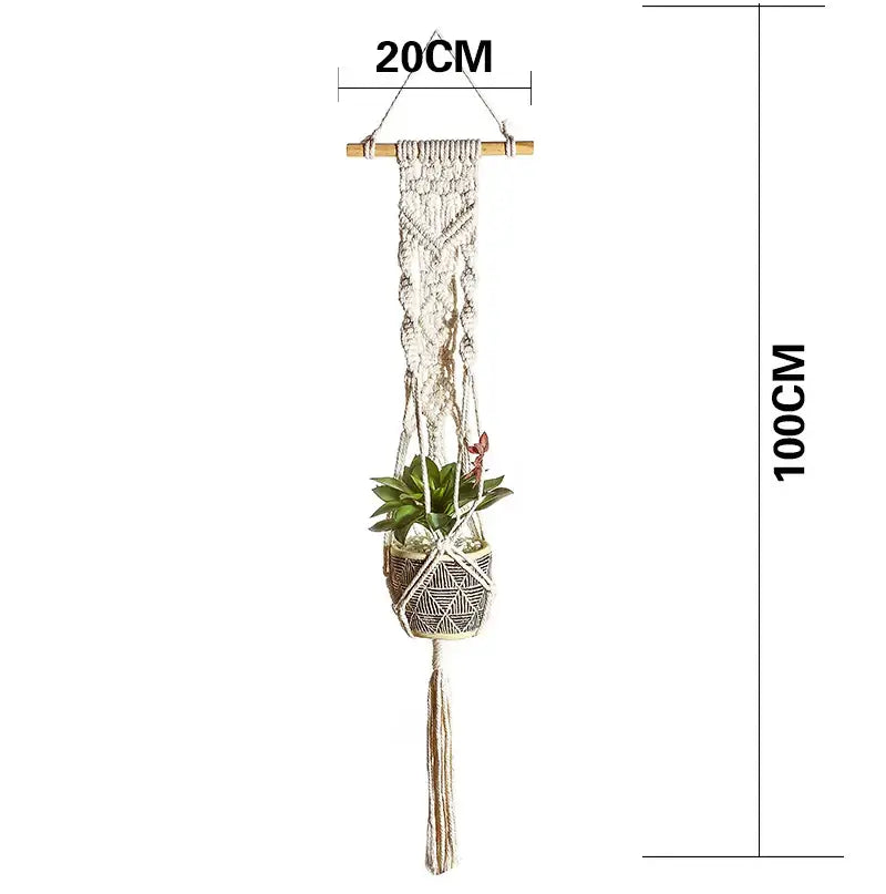 A cream-colored macrame plant hanger basket with woven geometric pattern wooden top bar and tassel for living room decor