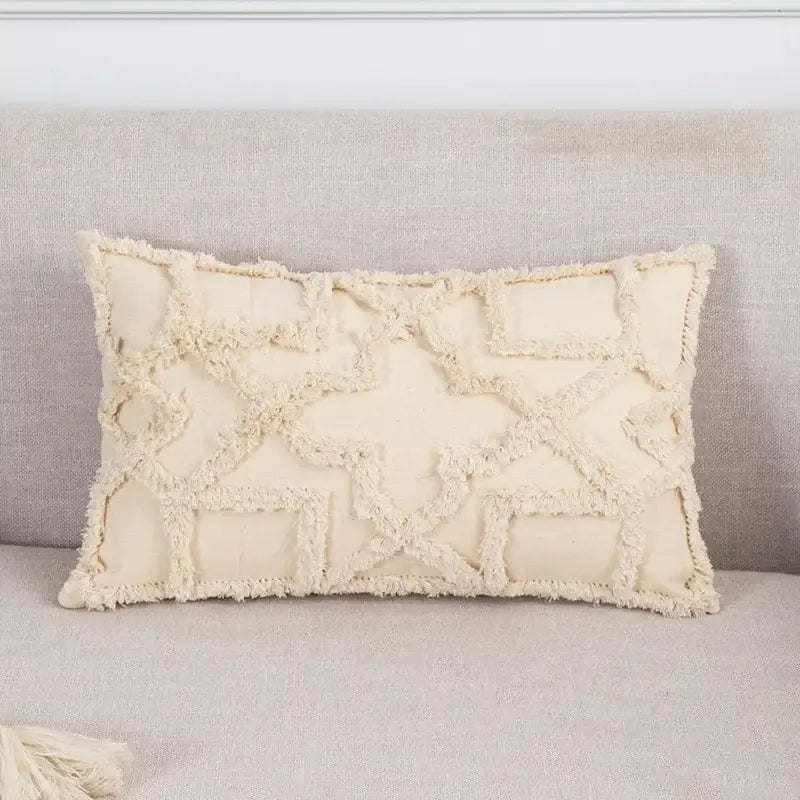 Cream-colored woven cushion cover with frayed geometric pattern and tassel trim for decorbites beige boho style decor