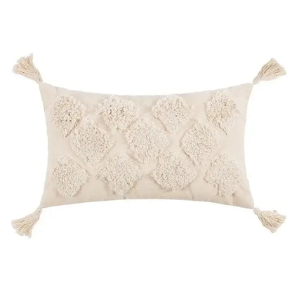 Cream-colored rectangular cushion cover with textured diamond-shaped and corner fringe tassels in beige boho style decorbites
