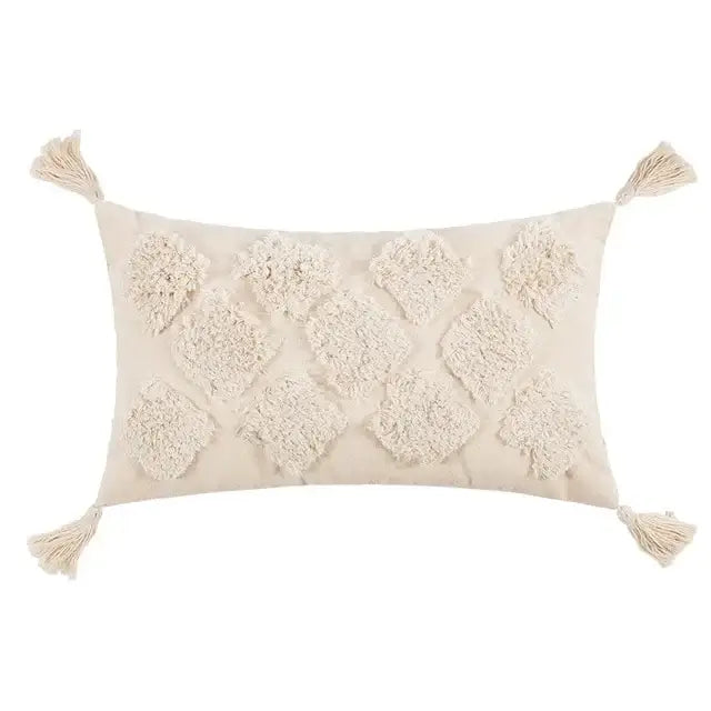 Cream-colored rectangular cushion cover with textured diamond-shaped and corner fringe tassels in beige boho style decorbites