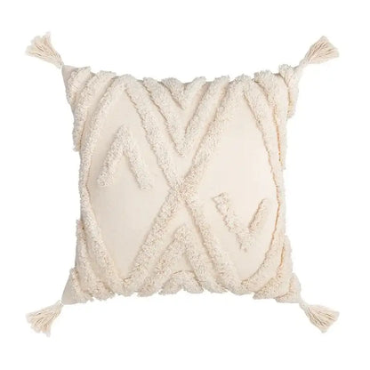 Cream-colored woven cushion cover with textured geometric patterns and tassels in decorbites beige boho style