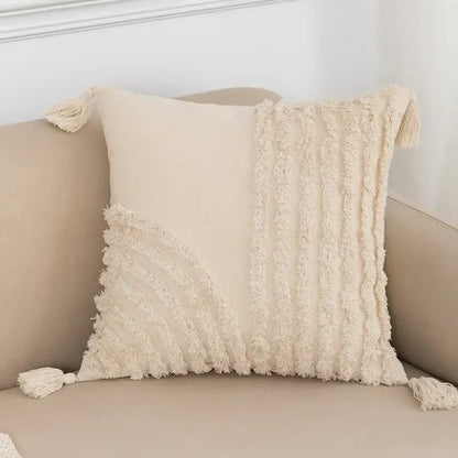 Cream-colored cushion cover with textured fringed fabric and tassels for decorbites beige boho style living room decor
